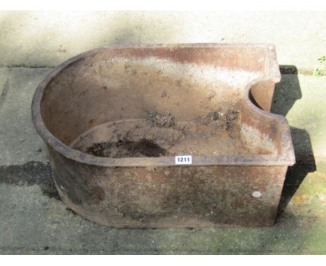 A reclaimed cast iron trough with single D end, partially inverted to other, 52 cm long x 40 cm wide x 20 cm deep