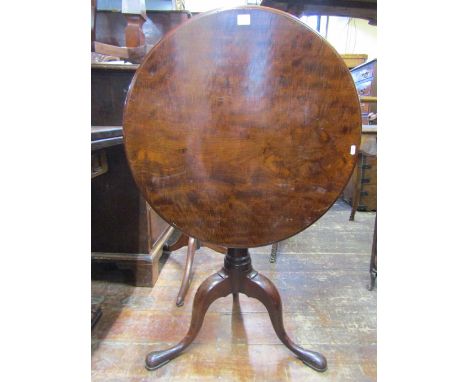 A Georgian mahogany snap top table, the one piece top 66cm diameter, raised on a tapered gun barrel pillar with sturdy tripod