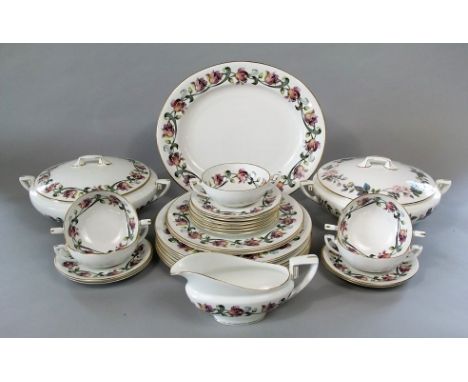 A collection of Royal Worcester Tulip pattern dinner wares comprising a tureen and cover, a further cover, an oval meat plate