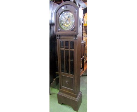 An early 20th century oak longcase clock, with arched hood, circular silvered dial, two train movement and partially glazed p