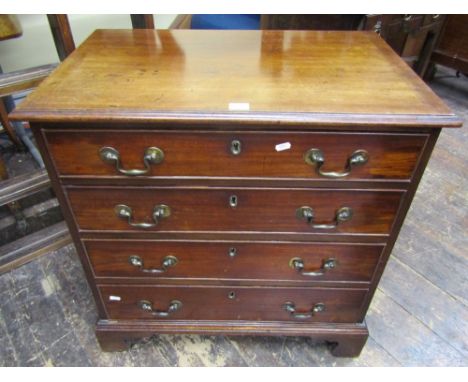 A small Georgian mahogany chest of four long graduated drawers with brass swan neck handles, raised on bracket supports, 73cm