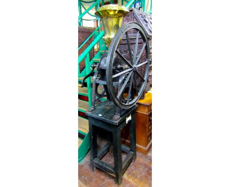 A high quality Victorian shop coffee or bean grinder by Parnall & Sons, Bristol, 73cm iron flywheel raised on two arched shap