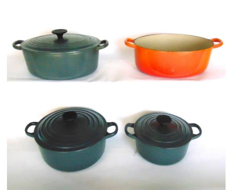 Three various graduated Le Creuset enamel lidded saucepans, together with a further orange example (no lid) (4)