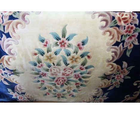 Large Chinese wool carpet decorated with typical floral sprays upon a blue ground, 400 x 280 cm 