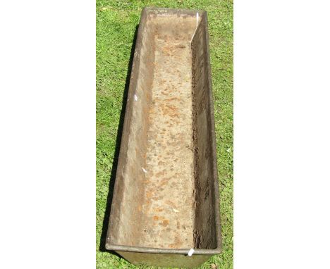 A vintage cast iron feeding trough of rectangular form with tapered sides, 188cm long x 40cm wide x 20cm deep approx