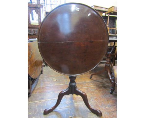 A Georgian mahogany snap top table the circular dished top raised on turned pillar and bird cage with shaped tripod base