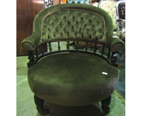 A low Victorian drawing room or occasional chair, with circular upholstered seat and arched button back, turned ebonised rail