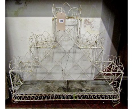 A good quality wirework conservatory/garden planter of stepped form with simple scroll work and lancet detail