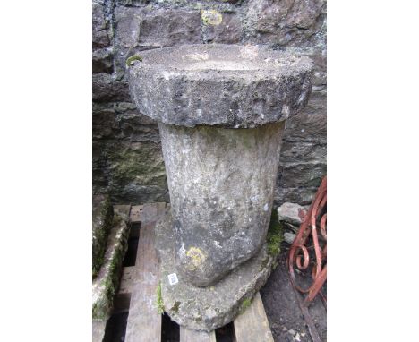 A weathered cast composition stone three sectional bird bath, the column/support in the form of a tree trunk 