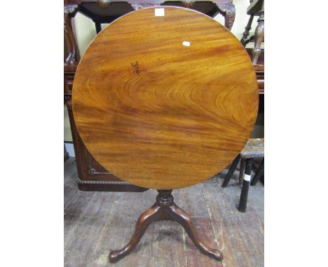 A good quality Georgian mahogany snap top table, the single piece top 75cm diameter, raised on a wrythen fluted column and st