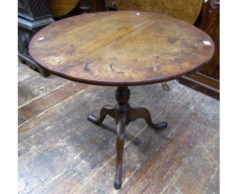 A Georgian oak snap top table, raised on a turned pillar and tripod base, 75cm wide