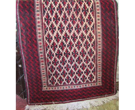 Persian thick weave wool carpet with geometric red and black pattern upon a cream ground, 180 x 10cm 