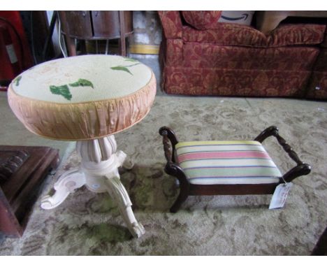 A Victorian piano or music stool with circular upholstered revolving seat, moulded vase shaped pillar and scrolled tripod wit