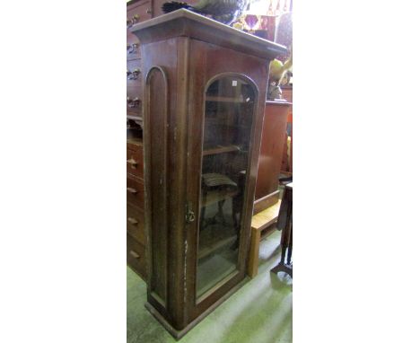 A Victorian mahogany side cabinet, enclosed by a full length arched, moulded and glazed panelled doors, flanked by further ar