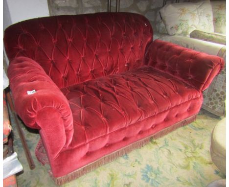 A small drop end Chesterfield sofa, with later upholstered buttoned finish in red velvet, 140cm wide