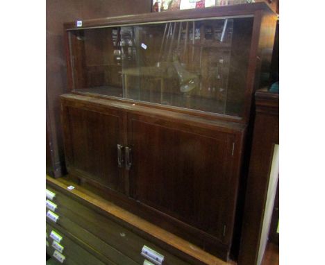 A collection of interesting Minty furniture comprising two glass topped cabinets over two cupboard doors together with a furt