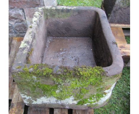 A natural stone trough of rectangular form with rounded front corners, approx 80cm long x 58cm wide x 40cm deep