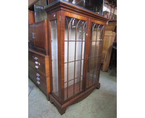 A good quality reproduction mahogany side cabinet, free standing and enclosed by a pair of full length glazed panelled doors 