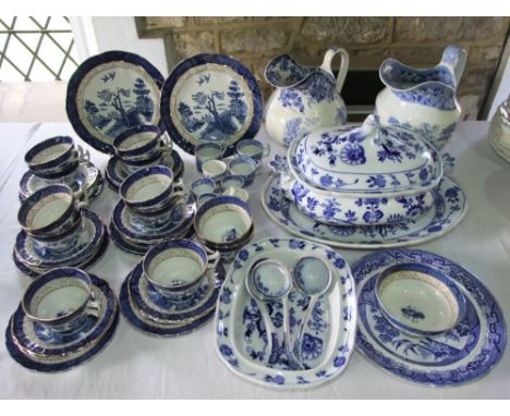 A collection of 19th century and other blue and white printed dinner wares including a Spode jug with village scene decoratio