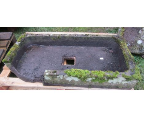 A shallow natural stone sink/trough or rectangular form with rounded front and central square drainage hole, 61cm long x 61cm