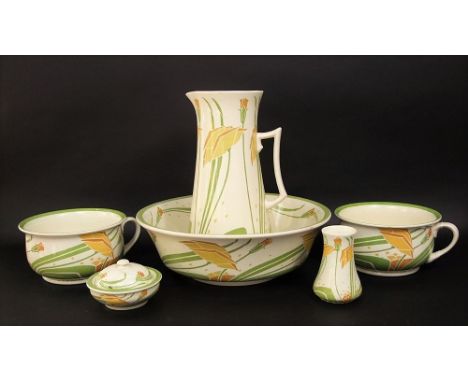 An early 20th century Minton's jug and basin set with stylised floral decoration in tones of green and yellow on a cream grou