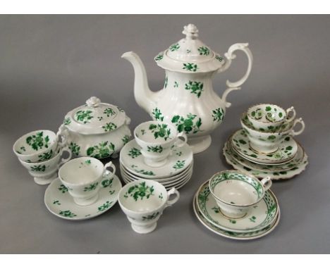 A collection of mid 19th century tea and coffee wares comprising a coffee pot with painted green floral sprigs and sprays and