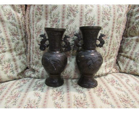 A pair of bronze Oriental vases with mythical beast handles 