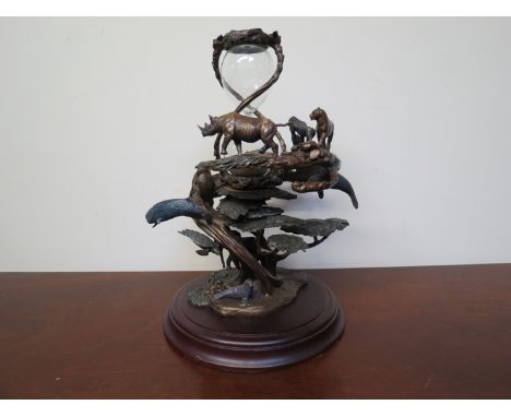 A bronze "Gaurdians of the world hourglass" figure by Steven D. Lord