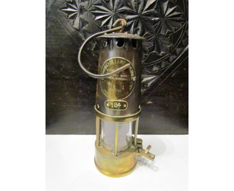 A brass and copper miner's lamp 