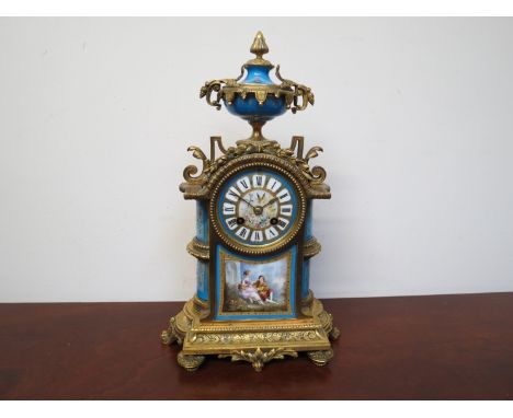 A 19th Century French Japy Freres mantel clock with gilded metal case, framed with Sevres panels and dial, urn held aloft, 8 