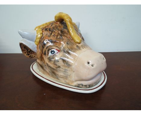 A late 19th Century ceramic cheese dish in the form of a cows head 