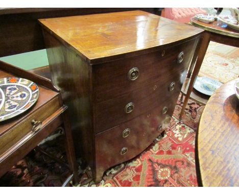 A 19th Century cross banded mahogany bow front cabinet of small proportions, the single door cupboard over a deep drawer on b