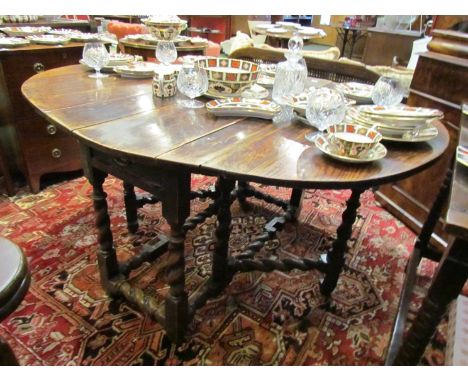 A late 18th/early 19th Century oak gate-leg table with barley twist supports 