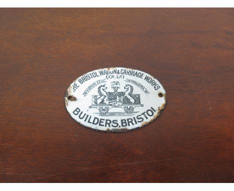 A late 19th Century enamel plaque "The Bristol Wagon & Carriage Works", 10cm long 