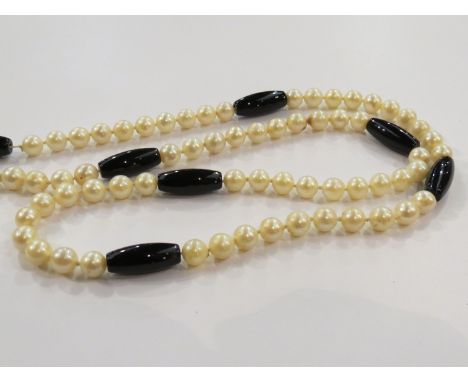 A cultured pearl necklace with glass bead dividers (appears to have one pearl missing)      