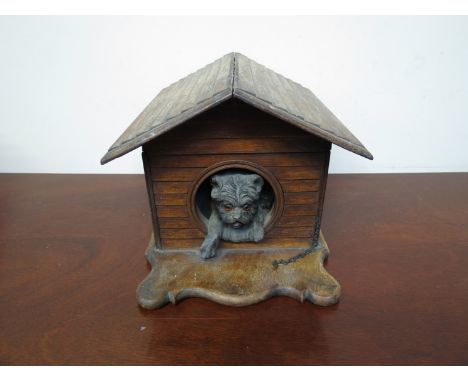 A Victorian cigar box in the form of a dogs kennel with bronze sculpted dog looking outward, compartmented interior, 17cm x 1
