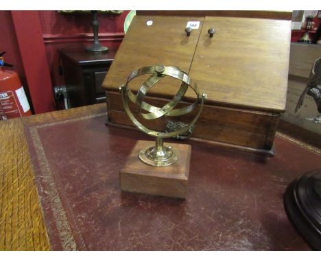 A set of brass yacht / ship lamp or compass gimbals or gimbles, mounted as a decorative piece on a mahogany base, brass marke