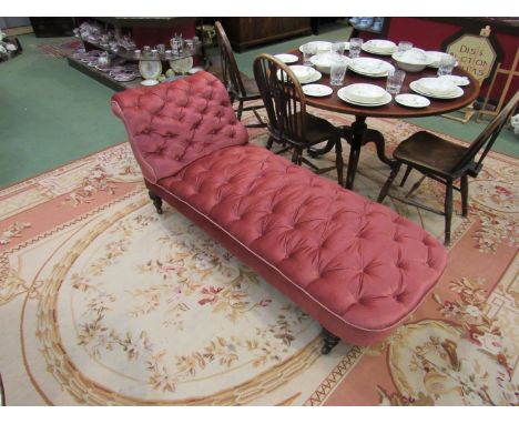 A Victorian scroll end chaise longue, the button upholstery over turned walnut feet and ceramic castors 
