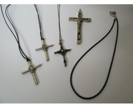 Four various white metal crosses, one set with seed pearl and garnet 