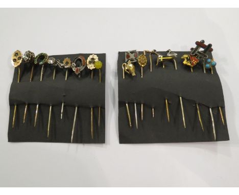 A collection of eighteen antique stick pins including gold and silver examples  