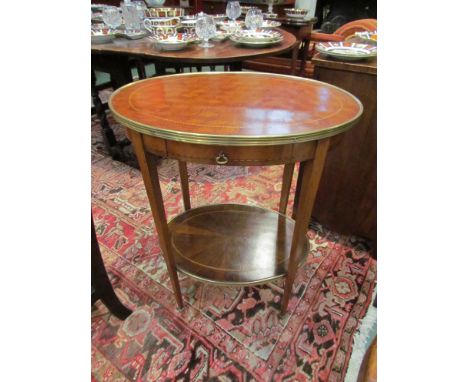 A French Kingwood parquetry and strung inlaid two tier lamp table with brass edge and single frieze drawer on square tapering