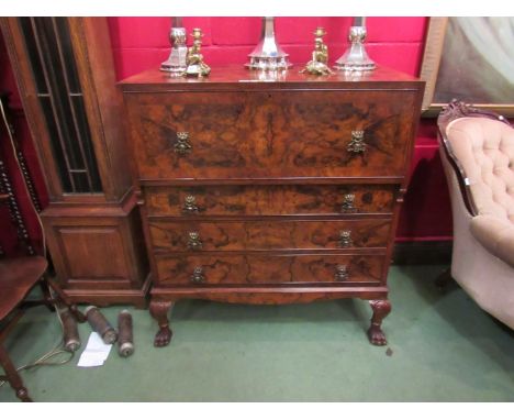 Attributed to "Maple & Co" a figured walnut caddy top, secretaire chest of four drawers on scroll carved cabriole legs with h