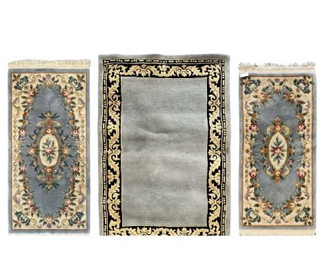 Chinese Art Deco light blue rug, wide black border with gold scrolling acanthus leaf design (180cm x 120cm); two Aubusson-des