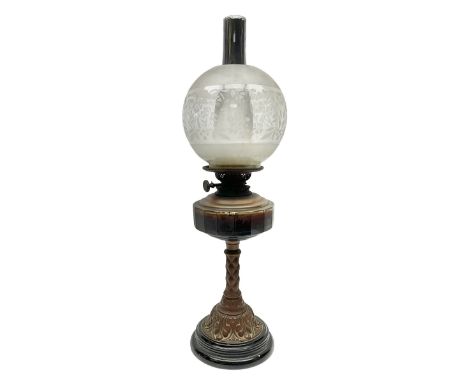 Victorian oil lamp, the faceted reservoir upon embossed copper stem and stepped circular ceramic base, with etched floral gla