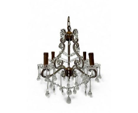 Mid-20th century brass and crystal chandelier, four scrolling arms adorned with hanging crystal prisms, central stem decorate