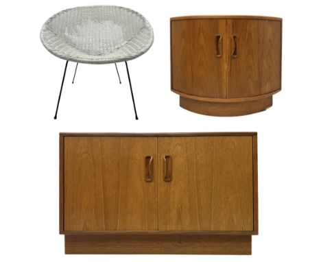 Mid-20th century corner teak cabinet, curved front with two cupboard doors, on plinth base (W64cm, D45cm, H53cm); teak cabine