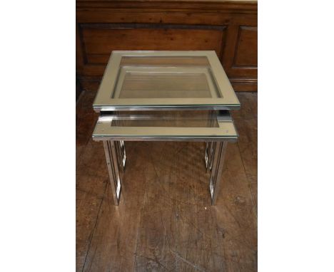 A pair of contemporary chrome framed lamp tables with plate glass tops. H.61 W.62 D.60cm (largest) 
