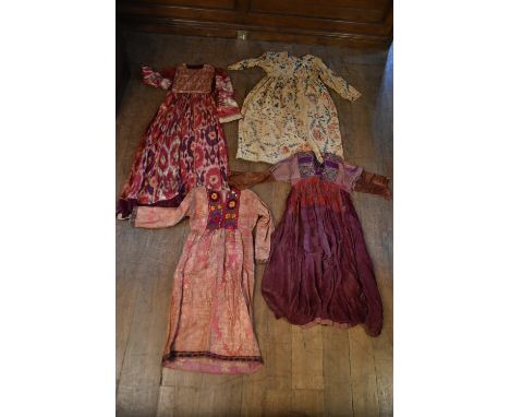 Four Asian antique patch work silk and cotton traditional dresses. Some with applied embroidery detailing and silver wire mot