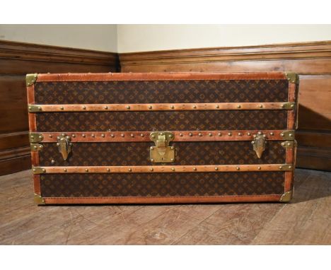 A C.1900 Louis Vuitton canvas monogrammed travelling wardrobe cabin trunk with original maker's label, brass leather and oak 