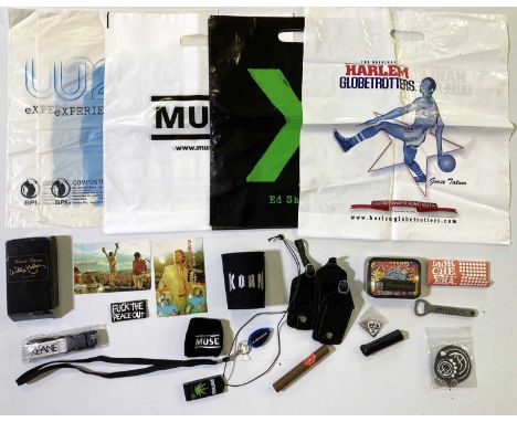 A collection of band-related tour merch and promo items. To include an Incubus bottle opener, Stereophonics tobacco tin &amp;